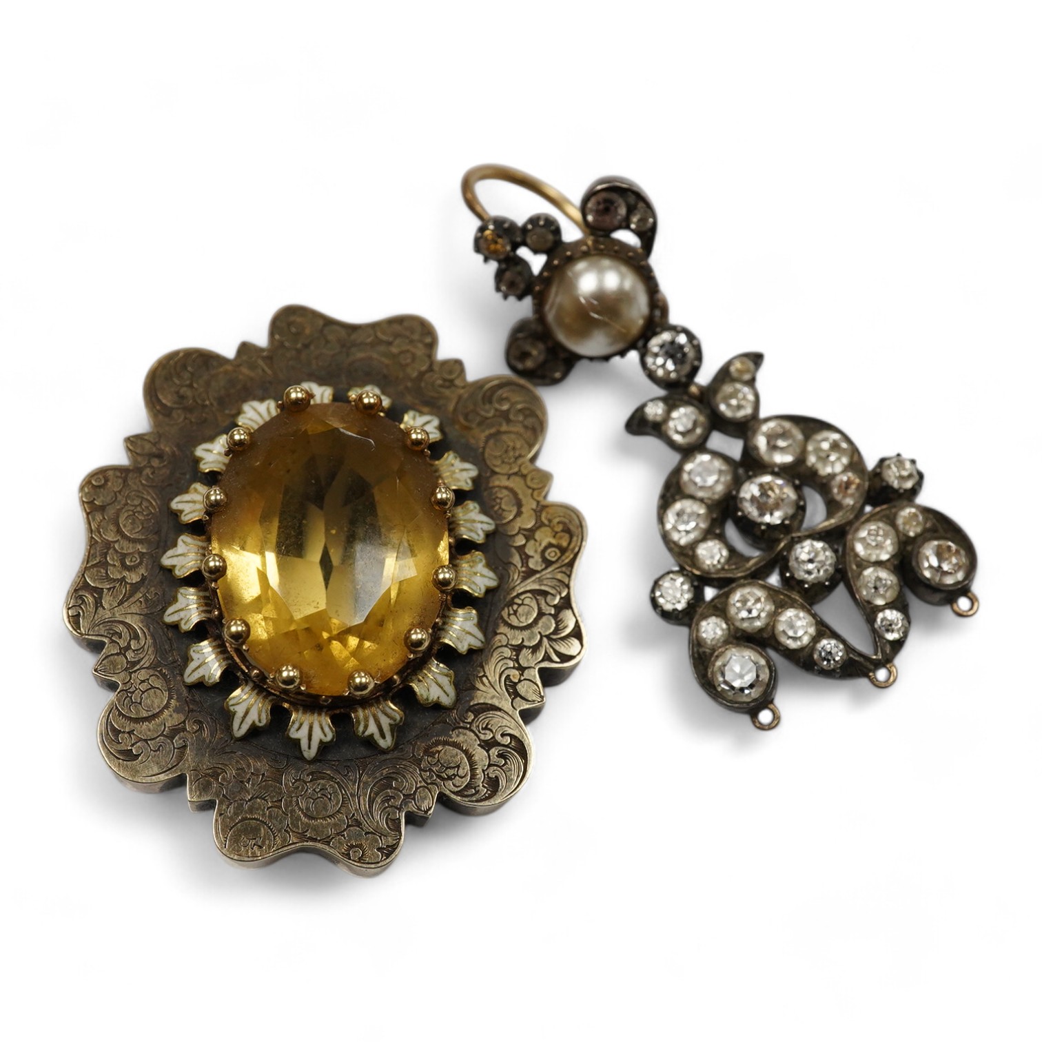 A citrine brooch and a paste and simulant pearl earring, 19th century, comprising: a brooch set with an oval citrine, within a lobed border engraved with floral designs, accented with white enamel, length 3.58cm; and a p